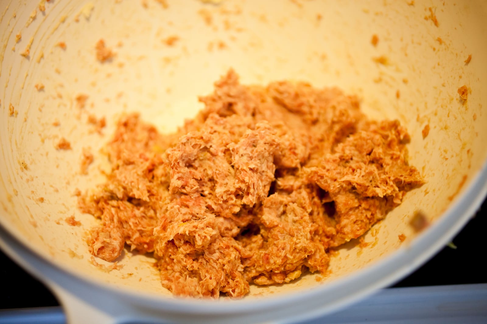 Seasoned ground-meat mixture gathered in a large mixing bowl.