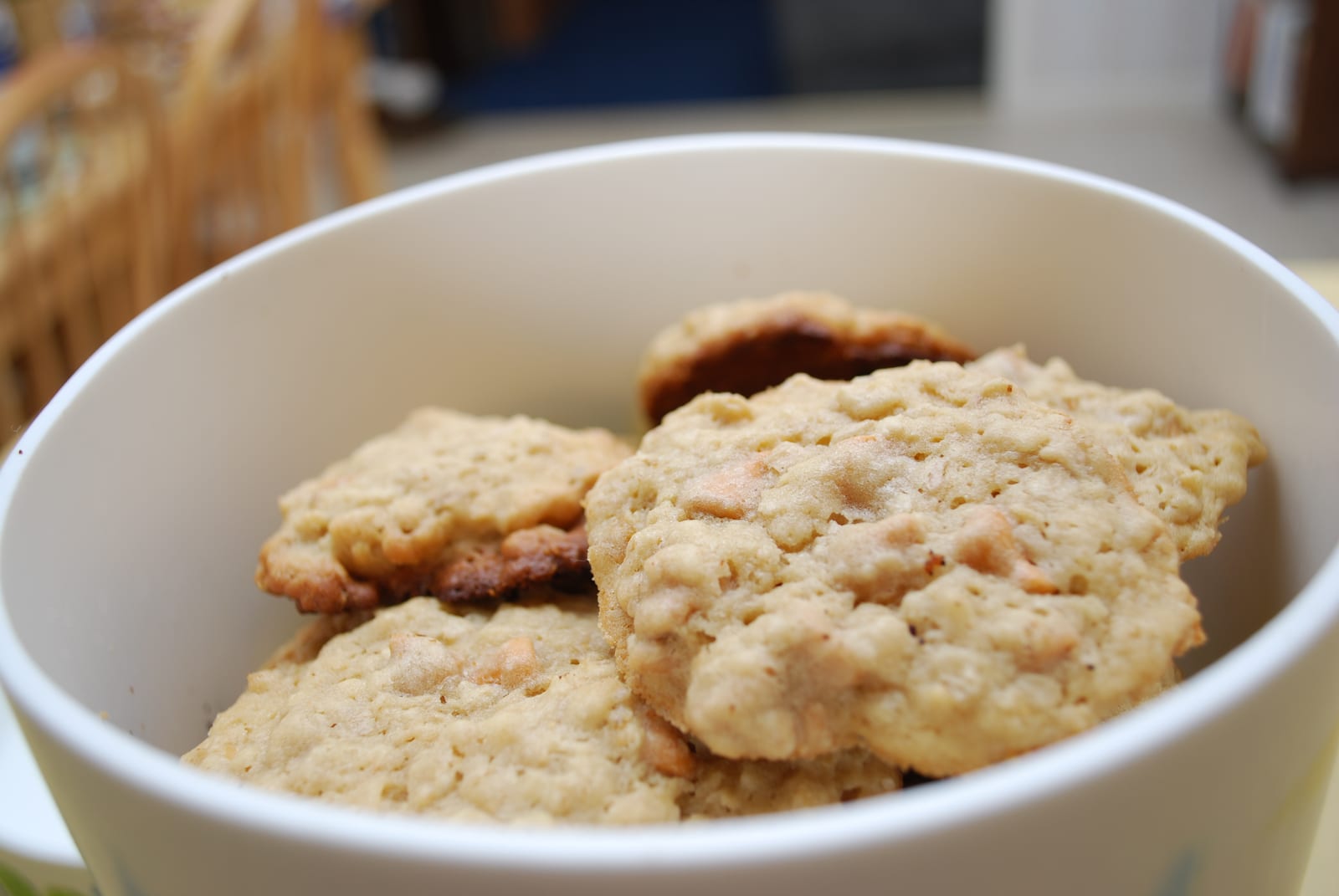 Pale oatmeal cookies with tan baking chips tucked into a wide ceramic cookie jar.
