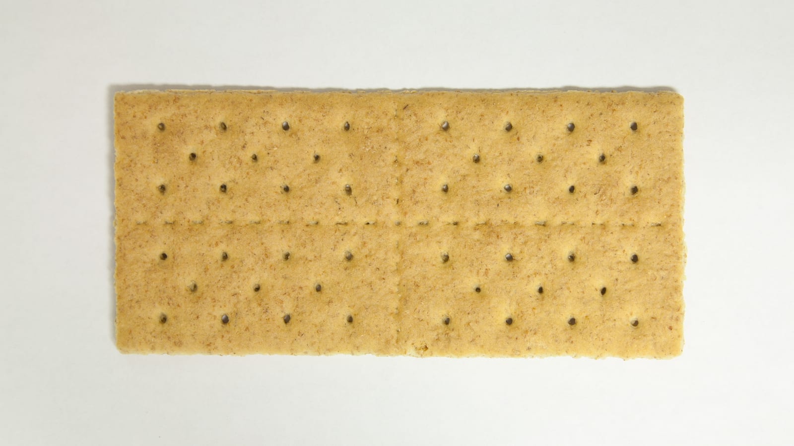 A single golden rectangular graham cracker against a white background.