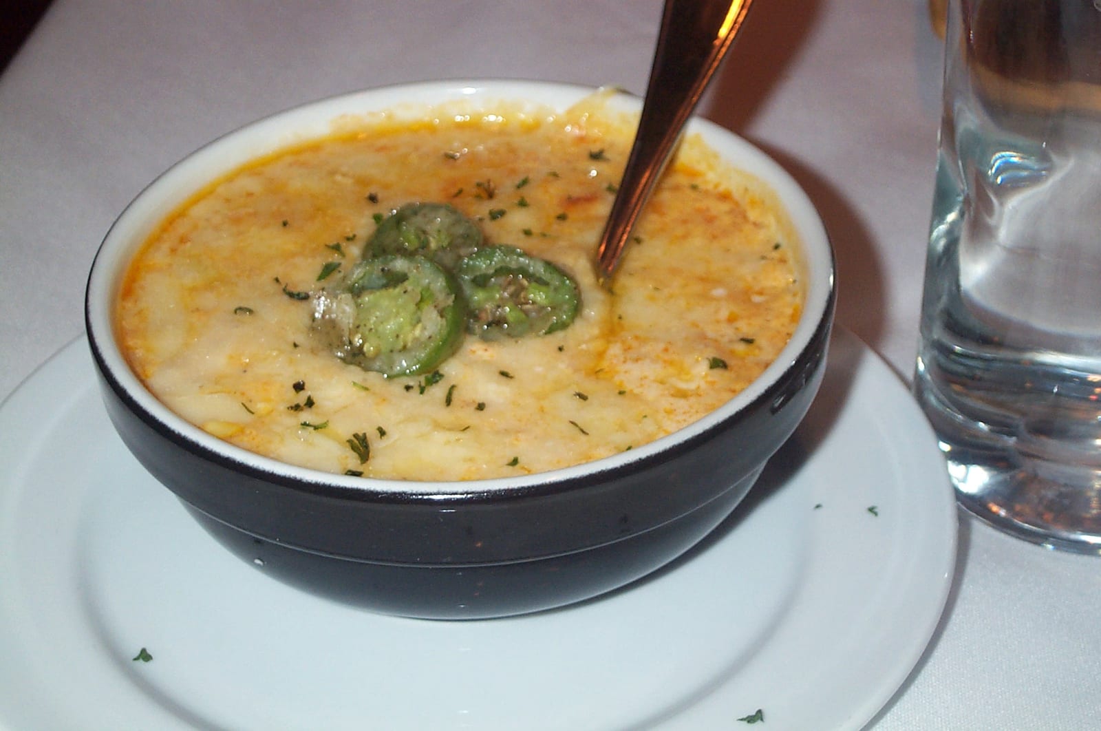 A white bowl filled with pale yellow creamed corn.