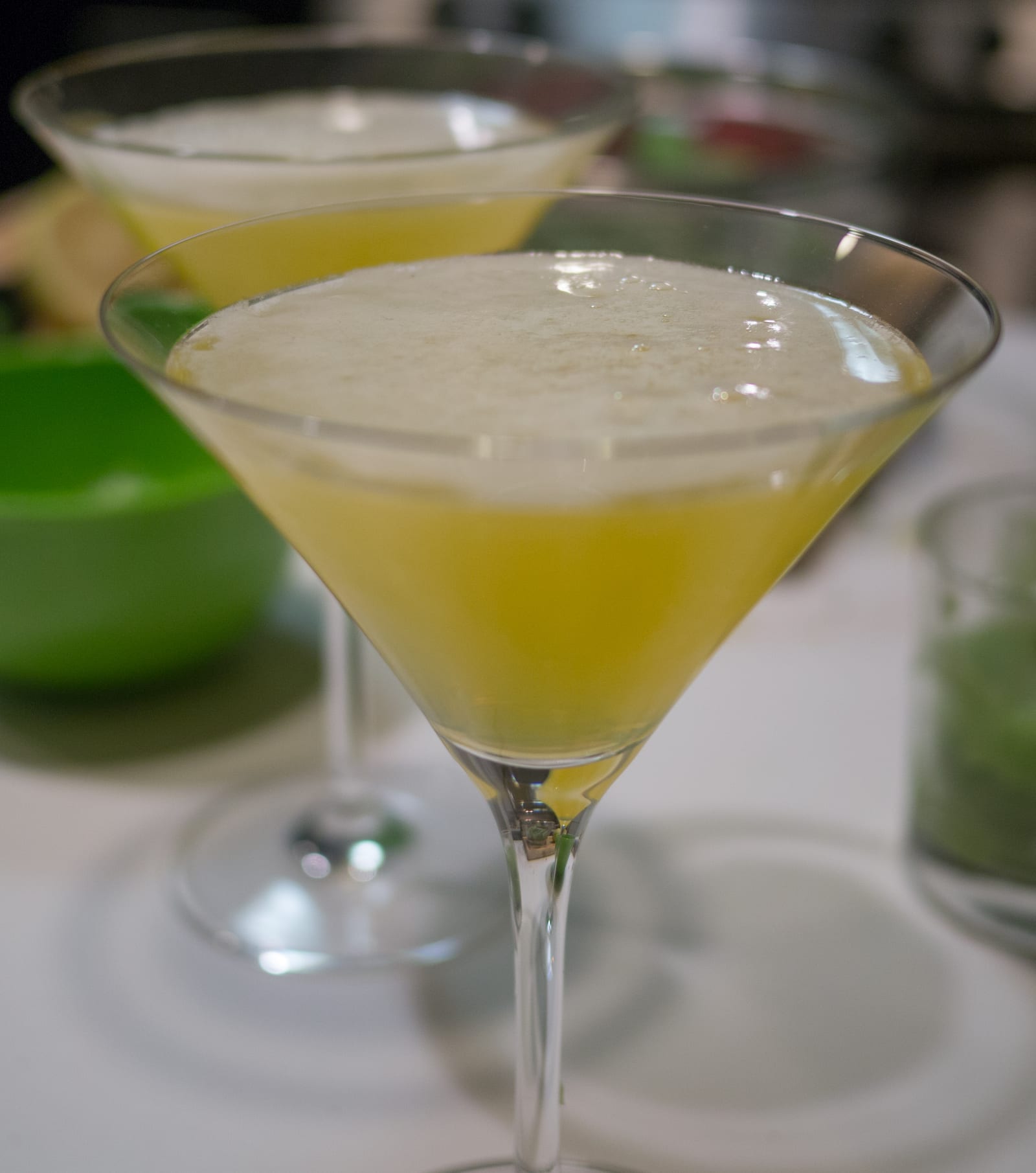 Two pale yellow Lemon Drop cocktails in sugar-rimmed coupe glasses.